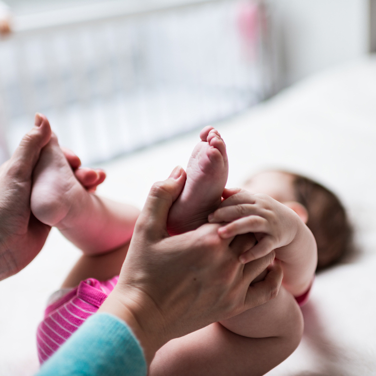 Little baby receiving chiropractic or osteopathic foot massage